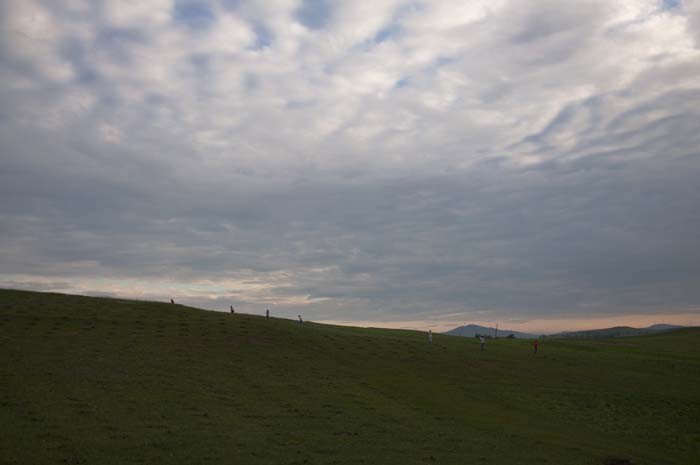 People heading up the hill at dusk